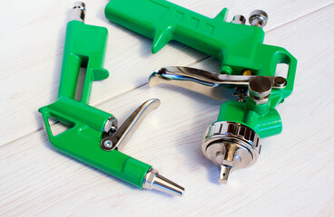 Green air compressor gun. Isolated on a wooden background