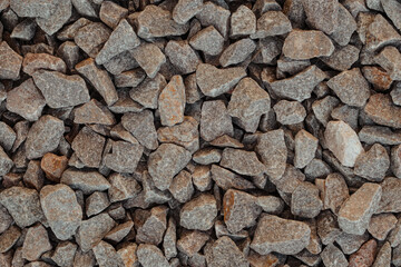 Horizontal photo of gray, white and orange stone textures.