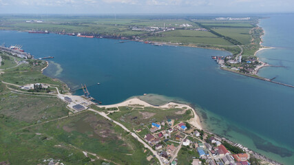 Aerial view of the sea bay. Blue water and boat trail.