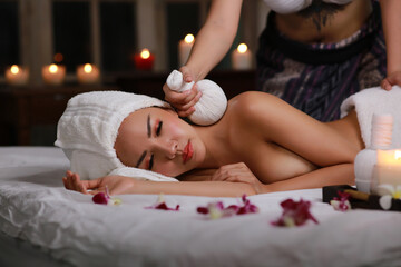 Obraz na płótnie Canvas Beautiful woman line down on floor getting spa and massange serivce, happy woman with healthy lifestyle in romanstic spa room