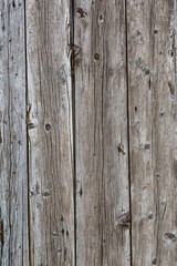 Fototapeta premium Old wooden fence gray-brown boards with cracked. Beautiful textured background for design.Old Vintage Rough Wood Bars Fence Texture Background.