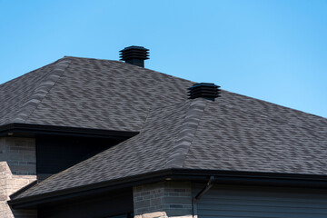 Ventilation covers on a new house shingle roof