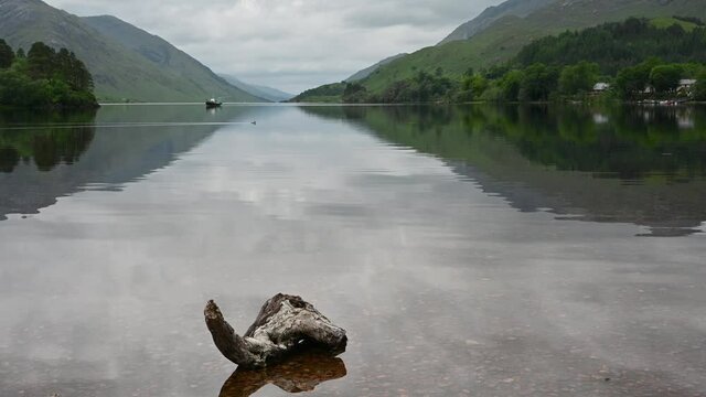 4k real time footage of Loch Shiel, Scottish Highlands with boat, birds and water movement. Accompanying audio which includes the distant sound of the famous steam train.