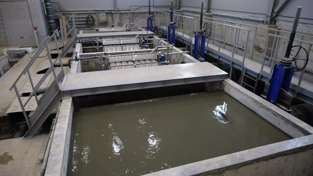 Large reservoir with dirty water and filters in spacious workshop of contemporary treatment plant view from above