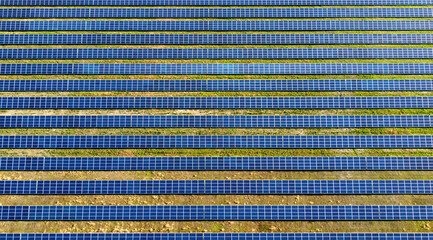 Aerial drone view flight over solar power station panels.