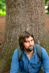 Man with long hair and beard looking up