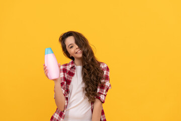 shampooing hair in salon. child with conditioner. long curly hair. daily habits and personal care.