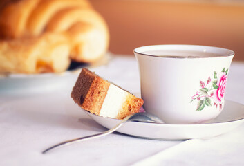 Cup of tea in a classic teacup served with cake