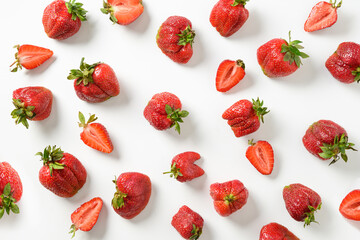 Pattern of ugly organic strawberry on white background. View from above. Concept organic products.