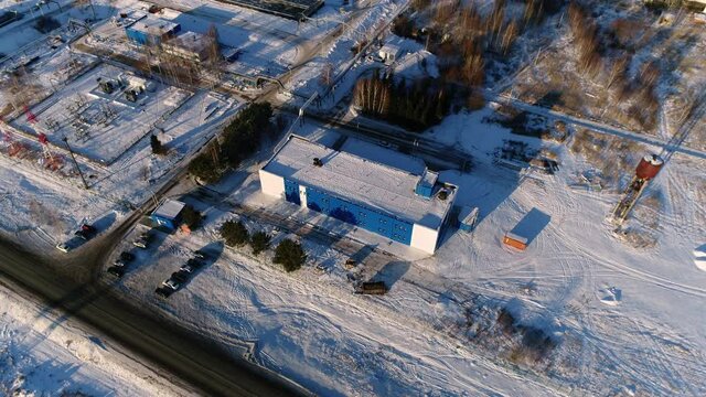 Workshops and small electricity distribution substation at wastewater treatment plant in winter evening bird eye view