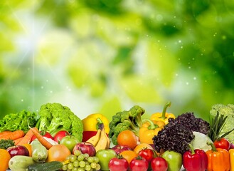 Panorama fruits, vegetables, berries on green blurred background
