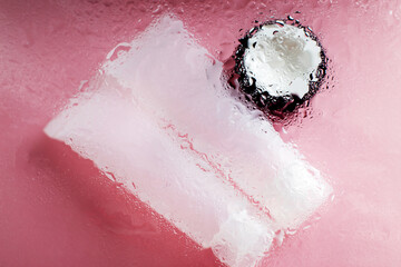 natural moisturizing skin care products. Face and hand cream under a glass surface with water on a pink background