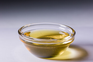 glass bowl with fresh golden liquid honey
