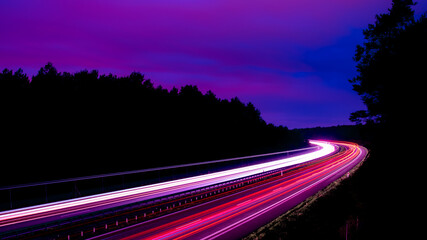 Night road lights. Lights of moving cars at night. long exposure