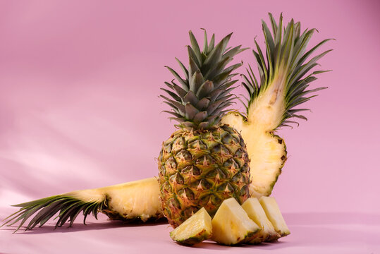 Fresh Ripe Pineapple and cutted slices of fruit against a pink background. Hello, Summer or Summer Season Sale Concept. - Powered by Adobe