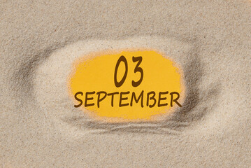 September 3. 3th day of the month, calendar date. Hole in sand. Yellow background is visible through hole. Autumn month, day of the year concept