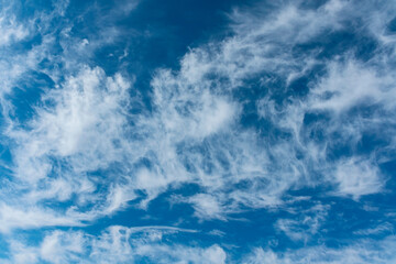 beautiful blue sky with cirrus clouds scattered by the wind as a natural background