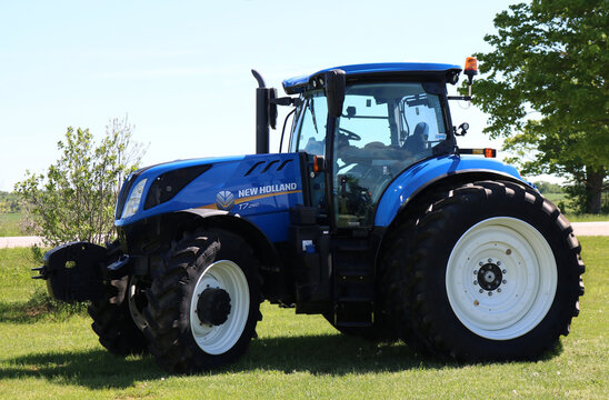 CHESLEY, CANADA - Jun 06, 2020: Large Blue Agricultural Tractor On Farm Equipent Dealership On A Sunny Summer Day