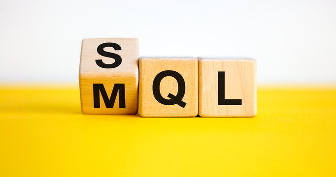 SQL or MQL symbol. Turned wooden cubes and changed words 'MQL marketing qualified lead' to 'SQL sales qualified lead'. Beautiful white background. Business and SQL or MQL concept. Copy space.