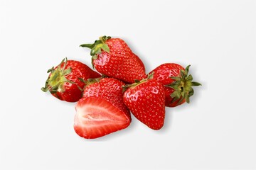 Delicious fresh red strawberries and green leaves on the desk