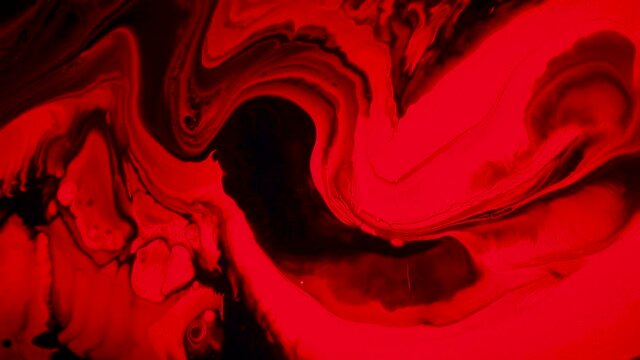Fluid art painting footage, abstract acryl texture with flowing effect. Liquid paint mixing backdrop with splash and swirl. Detailed background motion with red, black and orange overflowing colors.