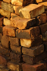 Stack with old brown bricks close up