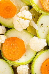 vegetables with baking spices. Slices of zucchini, carrots and cauliflower