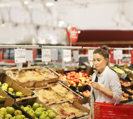 Woman buying fruits and vegetables at the market