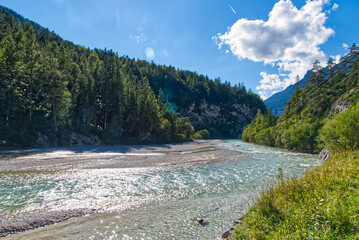 Vibrant shot of the Isar river in Austria on background of mountains
