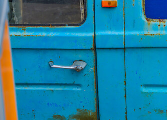Closeup shot of an old blue truck door