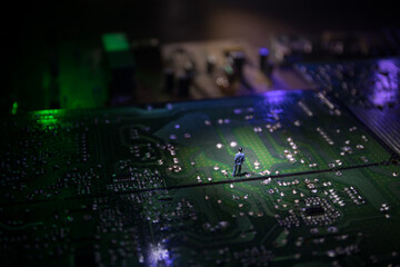 Stylized photo of an electronic microcircuit. Microcircuit, contacts, electronics, motherboard. Black background. Macro photography of electronic devices.