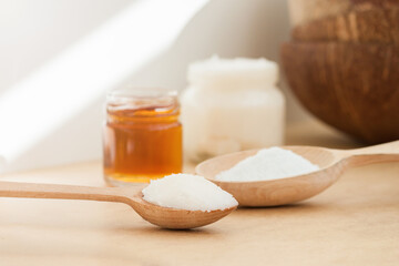 Coconut oil in jar and wooden spoon. Nature body, face, hair care concept.