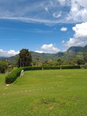 Fototapeta na wymiar Court and garden overlooking the rural landscape Jardín, Antioquia, Colombia.