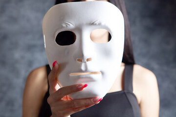 woman holding a plastic mask