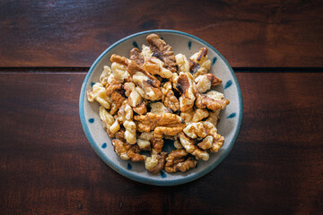 Small bowl of cracked walnuts for snack