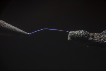 Electric cable close-up with glowing electricity lightning. Macro shot