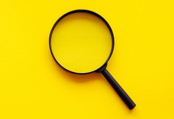 magnifying glass magnifier loupe search symbol on yellow background with copy space