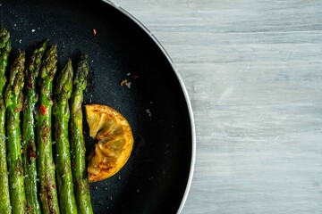 Organic bio fresh green asparagus harvest for cook grill roasted vegetable salad meal food with lemon and salt	