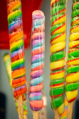 Fototapeta na wymiar Colorful Spiral Lollipops in wrappers at a candy store
