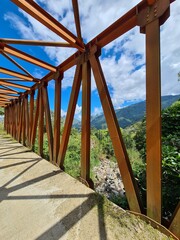Rural landscape with mountains and blue sky.
Yellow metal bridge on the way to Venice, Antioquia, Colombia.