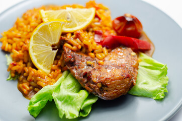 Spicy chicken breast and long grain rice with red peppers, tomatoes and jalapeno chillies