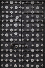 Picturesque doors of an Orthodox church decorated with silvery flowers