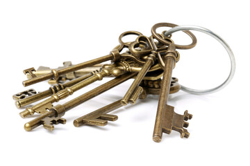 old brass key against a white background