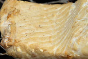 Photo of a King Salmon Fillet while cooking above a fire pit on a sunny day of June 20, 2021. Below...