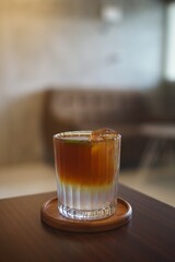 selected focus of iced coffee with soda on a table in a cafe 