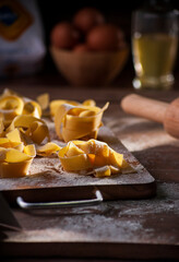 pappardelle pasta on a kitchen board with sunlight streaming through the window, blurred background . copy space