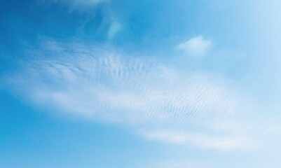 Naklejka na ściany i meble Beautiful clean blue sky with puffy clouds background