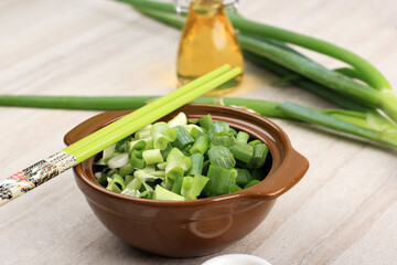 Sliced, Chopped Spring Onion in Brown Bowl with Chopstick. Preparation Making Chinese Korean Cooking