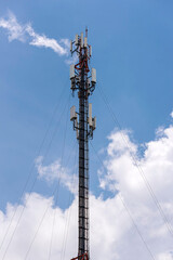 Telecommunication tower with blue sky and cloud