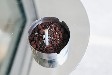 Astray with cigarettes butt inside on table. Relaxing time bad habits lifestyle,